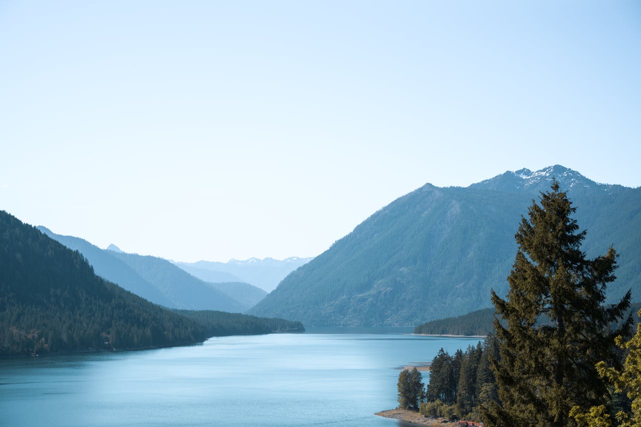 Blue Lake Surrounded By Pine-Covered Mountains