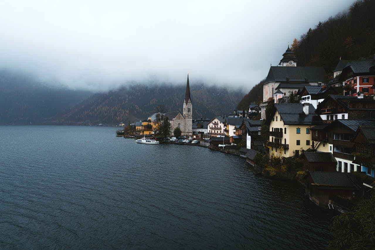 Lakeside Village With Church Steeple Under Cloudy Sky